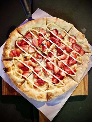 Dessert pizza with strawberries and bananas