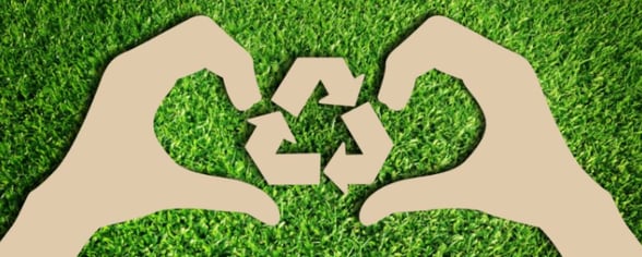 Cardboard cutouts of hands and recycle icon
