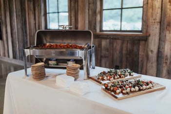 Caprese skewers and a chafing dish of hot food