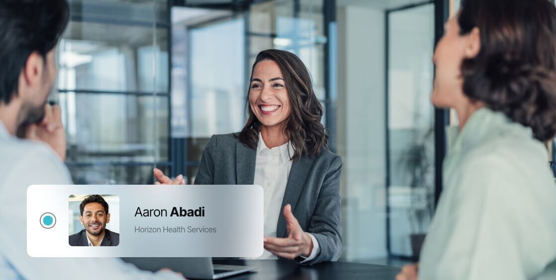 three people in an office chatting