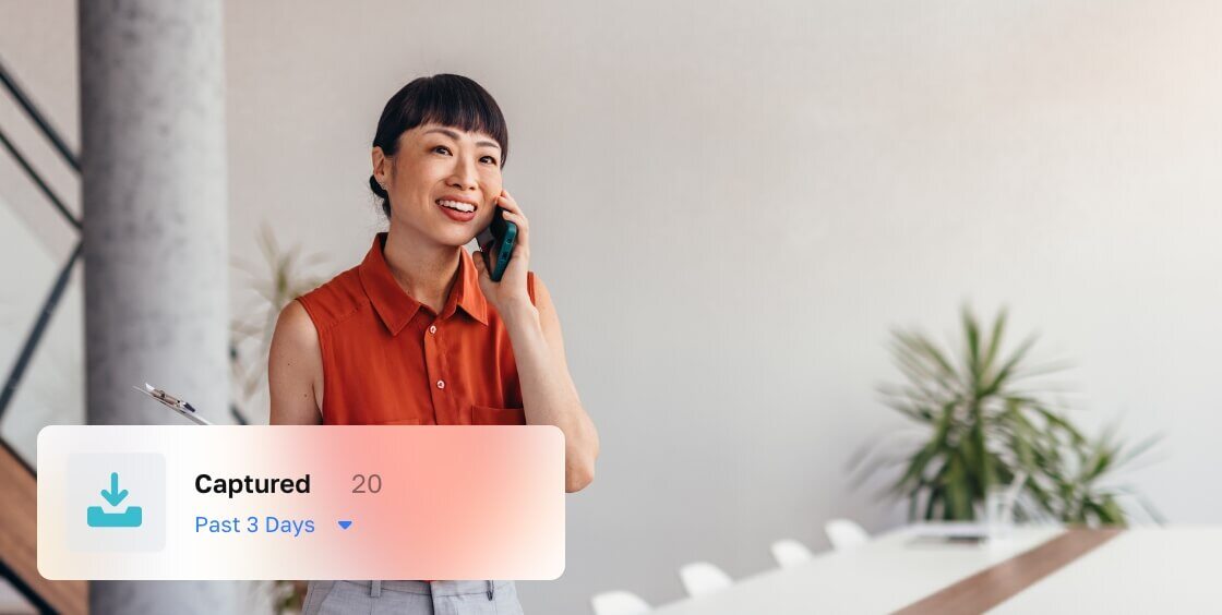 a woman talking on the phone clutching a tablet